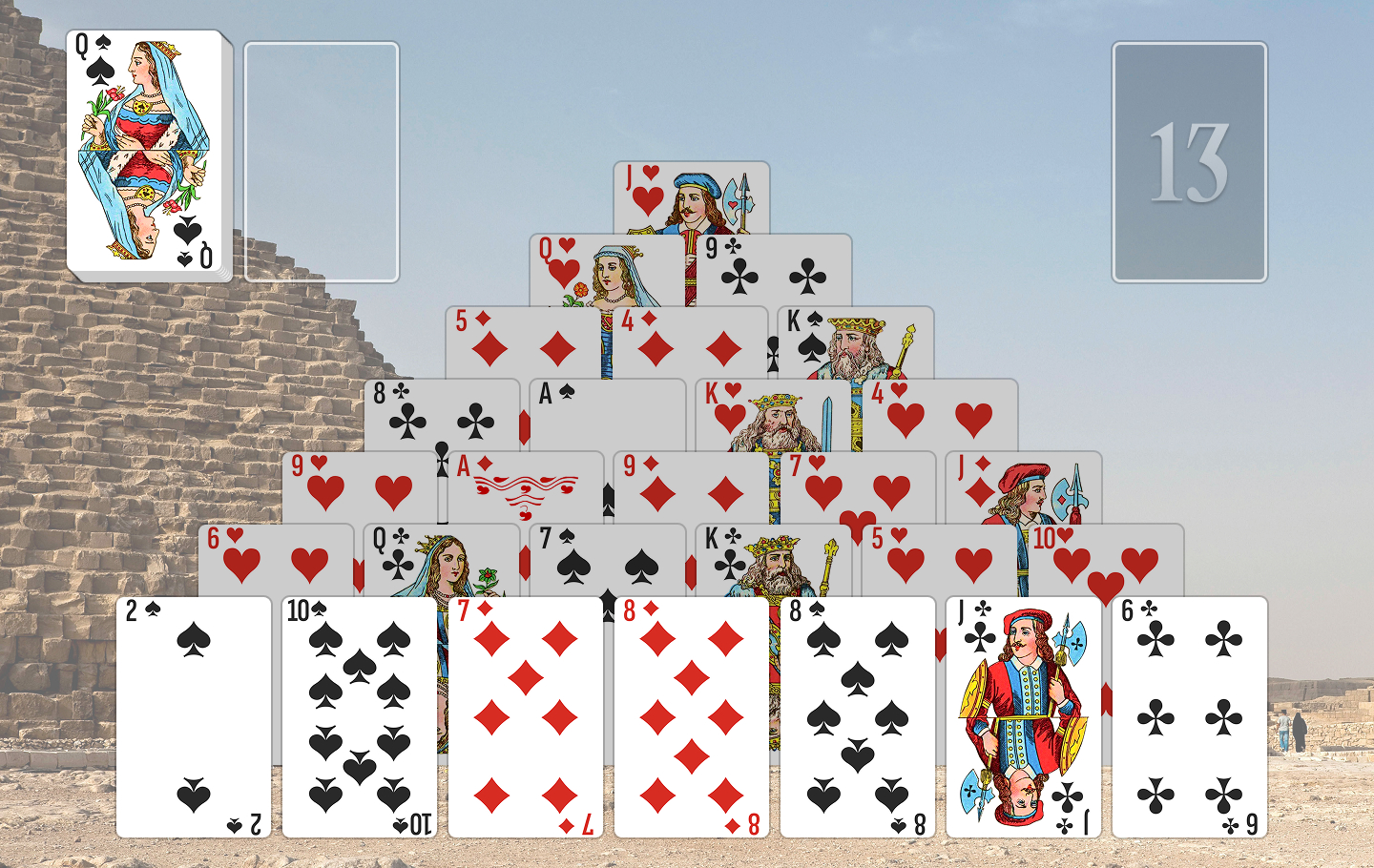Golf Solitaire game board with cards stacked in a pyramid over a stone pyramid background.